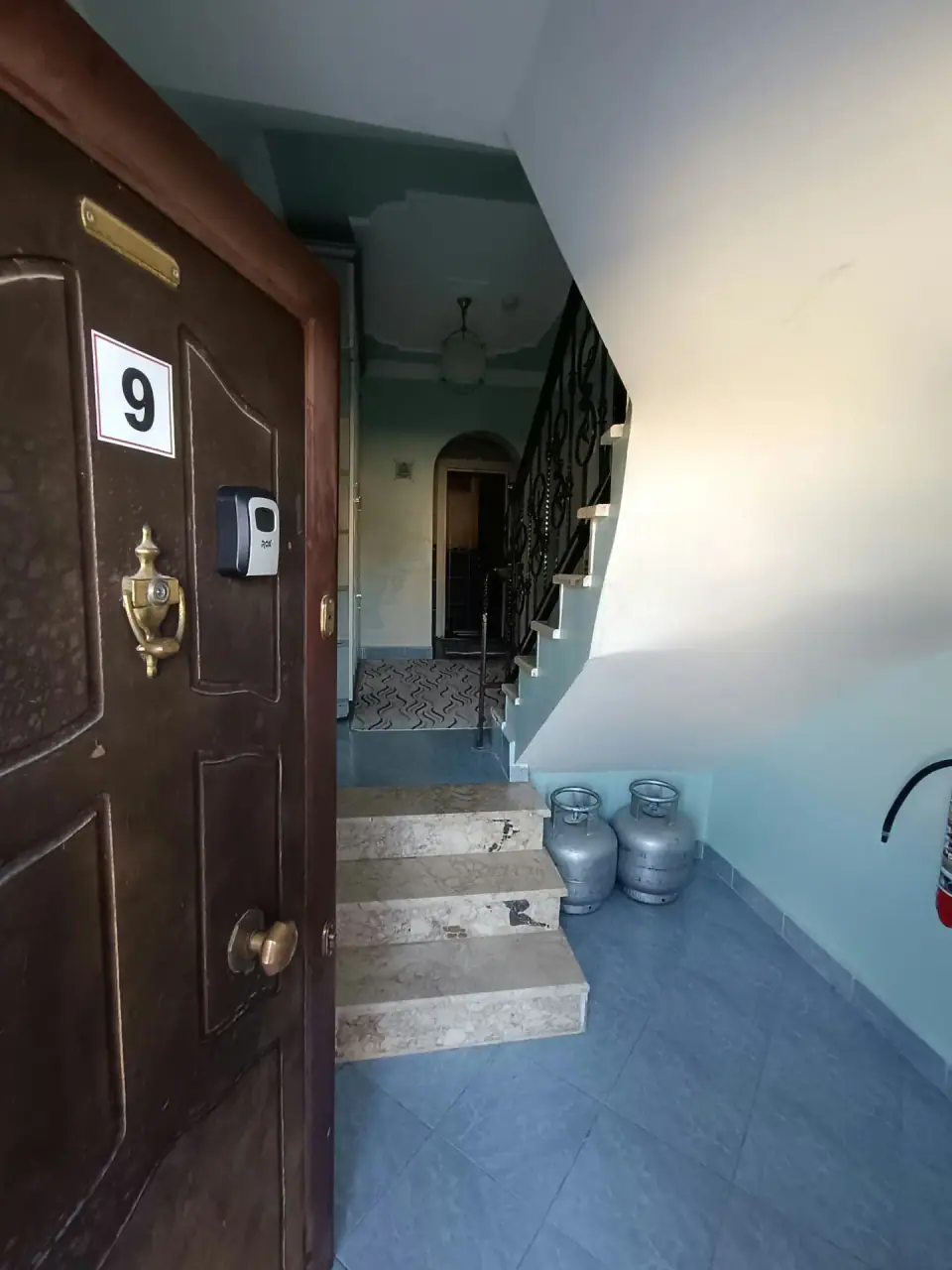 The No. 9 front door and the marble staircase inside