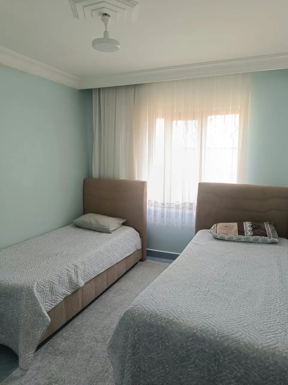 The second bedroom and its two single beds in daylight
